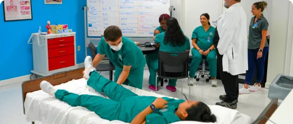 students at Ultimate Medical Academy’s Clearwater, FL location practicing their clinical skills as part of a healthcare education program