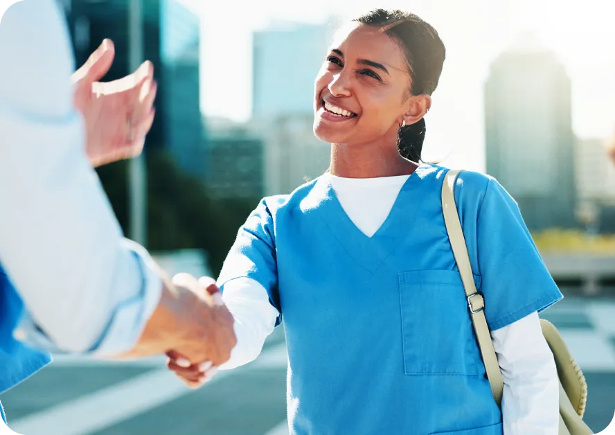 a post-graduate student shaking hands with a recruiter smiling