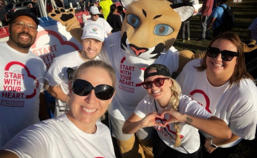 A group of UMA advocates with Journey the Puma mascot
