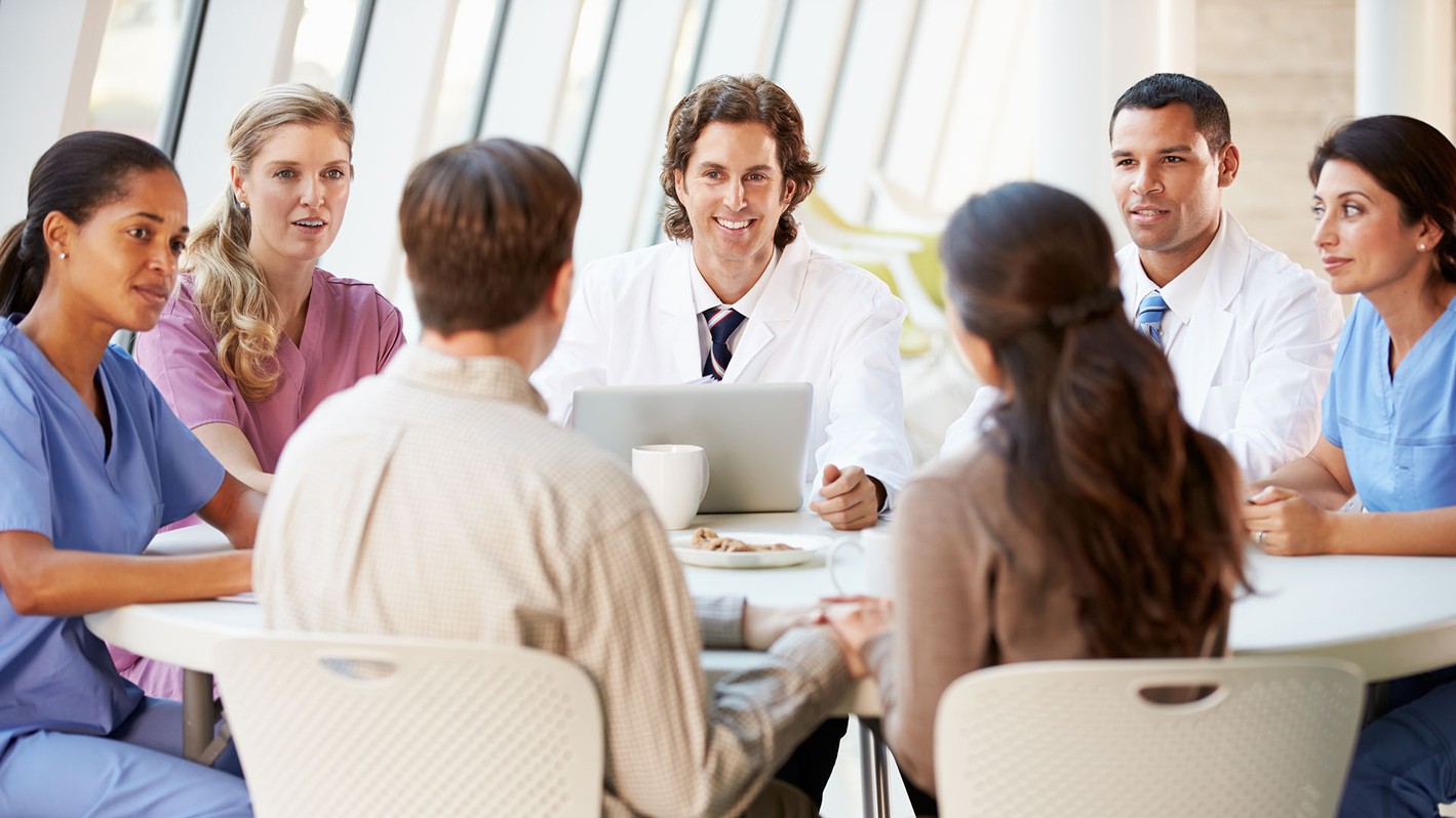 Image of a meeting with employees in the healthcare management and healthcare administration field.
