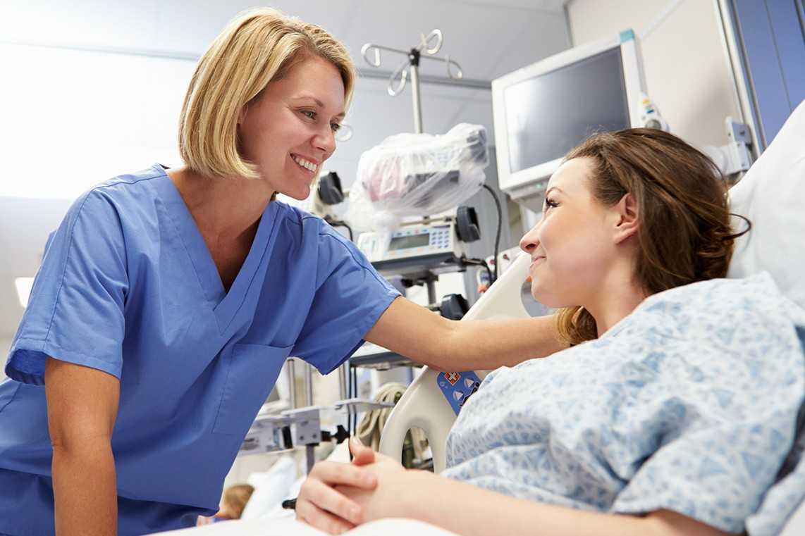 A nursing assistant cares for a patient