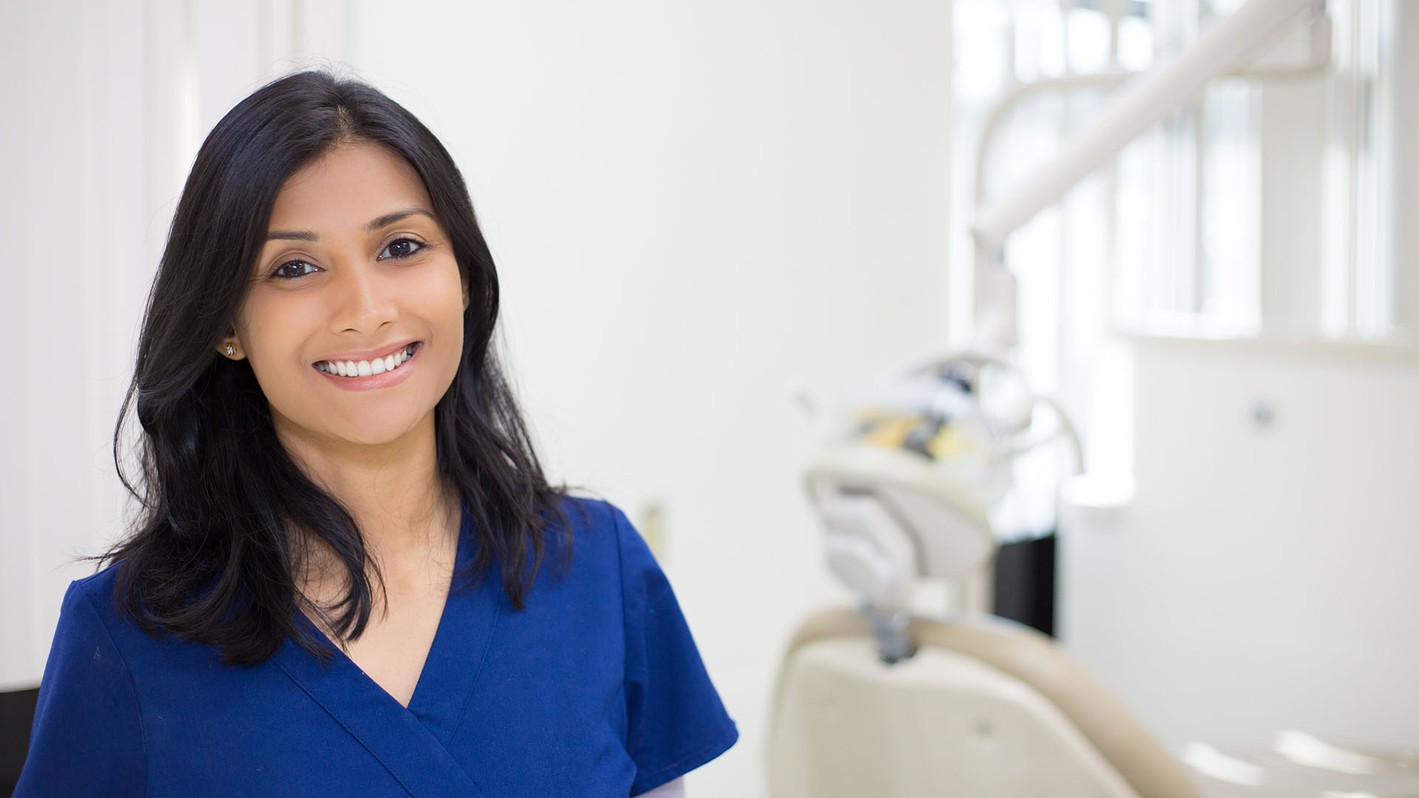 Image of a dental assistant smiling while working.